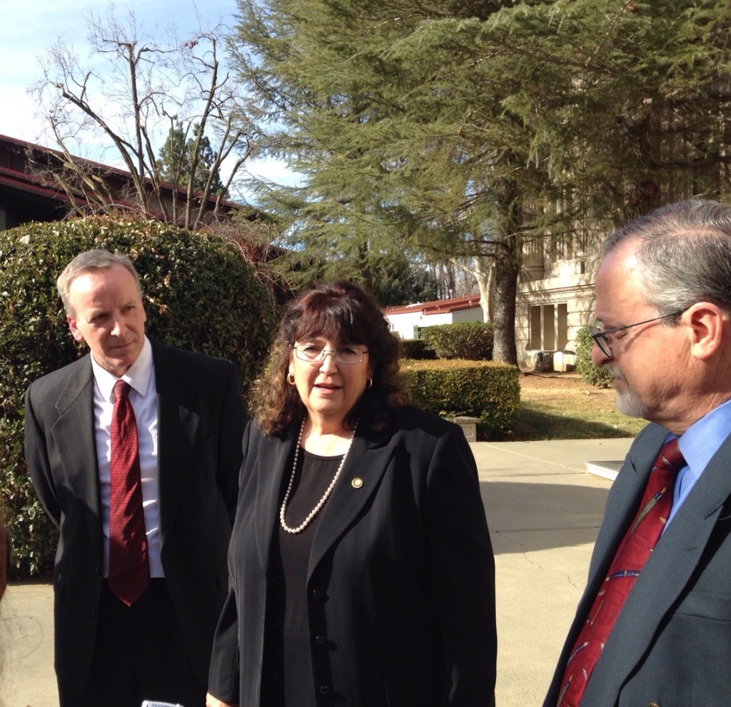 Janene Baronio talks to reporters after announcement, flanked by Judge Fall (left) and Judge Rosenberg (right)