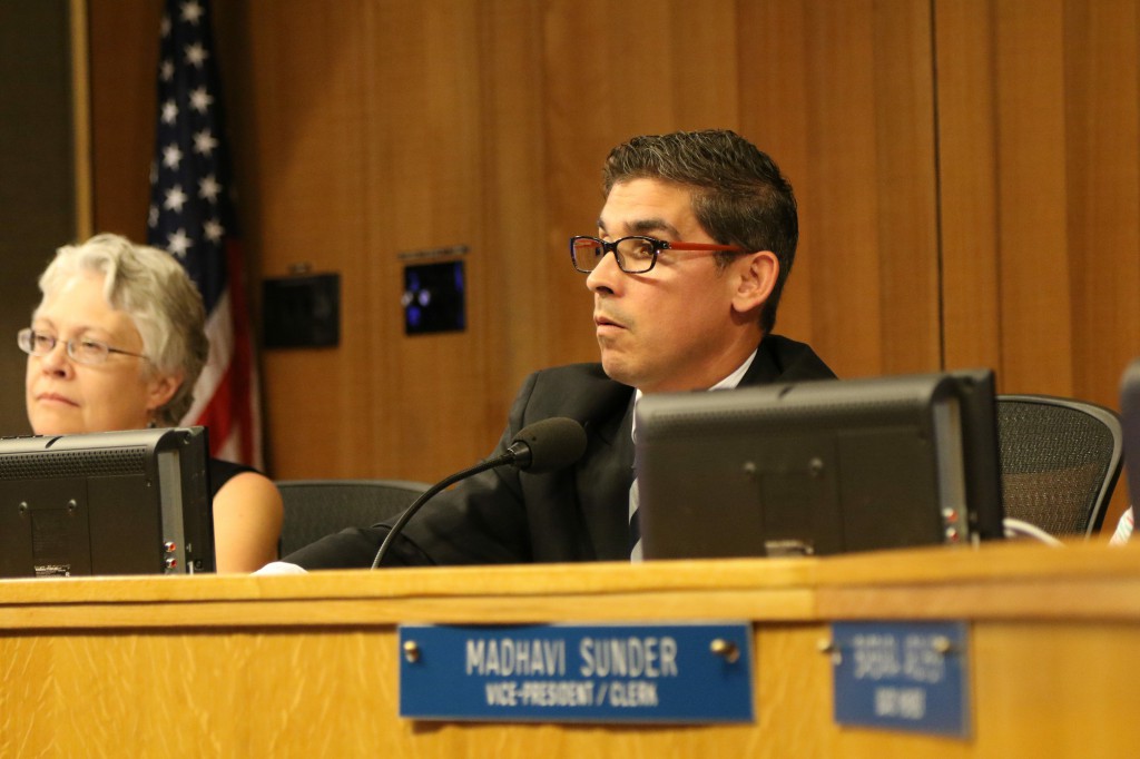 Board President Alan Fernandes listens to public comment